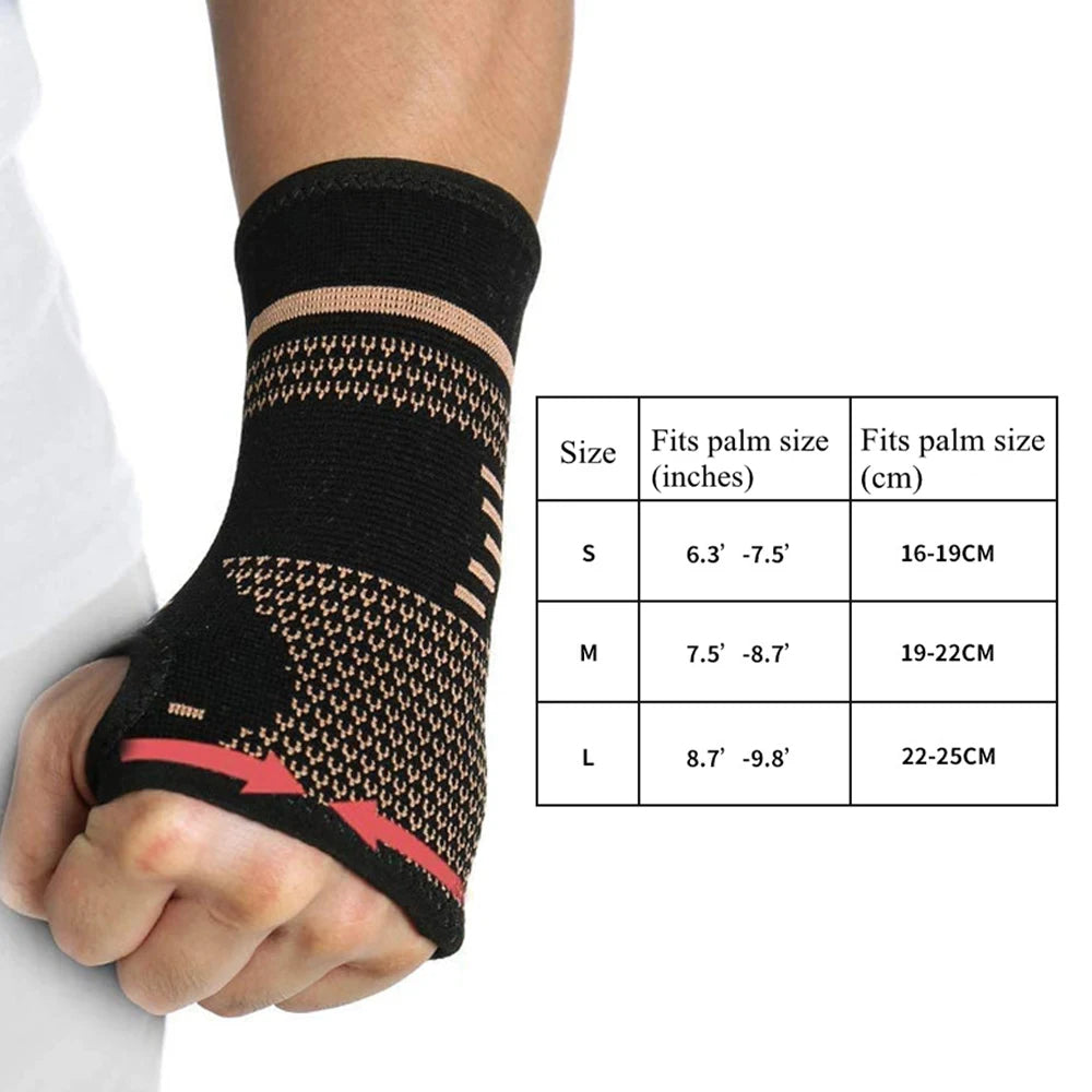 Hand wearing a black wrist support with size chart on a white background