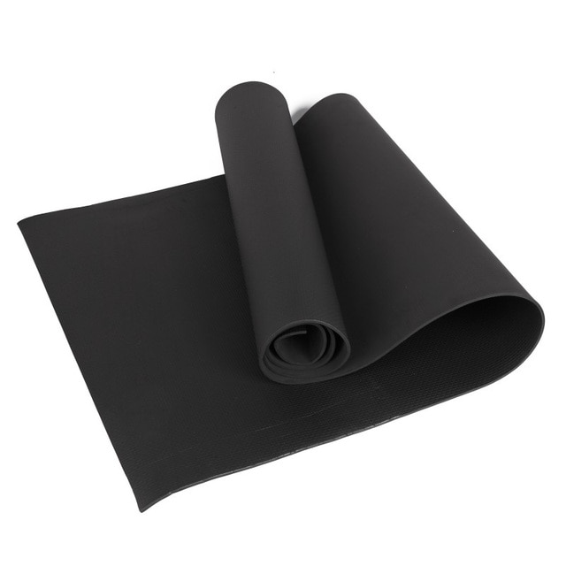 Black yoga mat rolled up on a white background