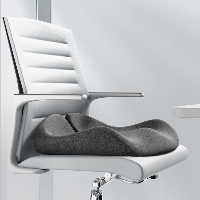 Orthopaedic memory foam seat cushion, front view on chair, contoured cut-out supports tailbone and lower back comfort.