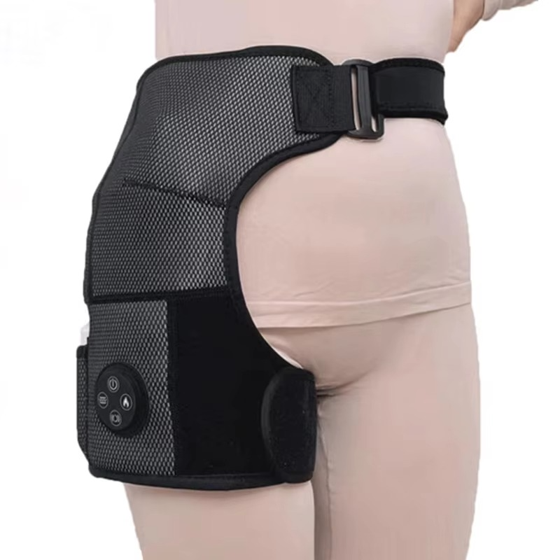 Black knee brace with electronic components on a person's leg against a white background