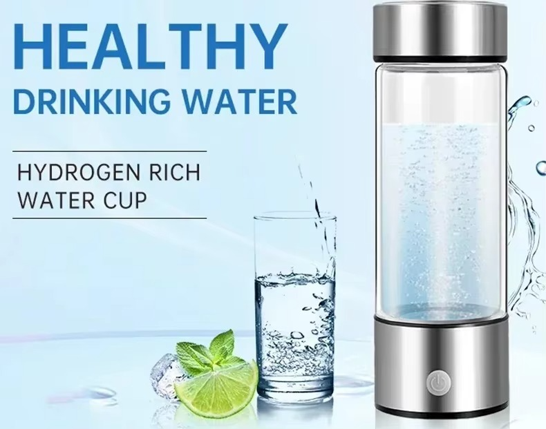 Hydrogen rich water cup with a glass of water and lime wedge on a light blue background.
