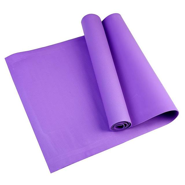 Purple yoga mat rolled up on a white background