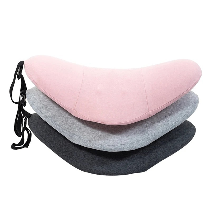 Memory foam lumbar pillow in dark grey, front view, with rollable design and ergonomic shape to help support the lower back.