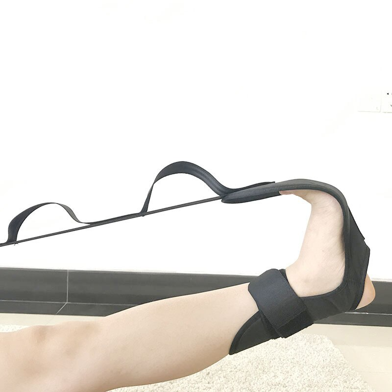 Person using a resistance band for leg exercise on a white background