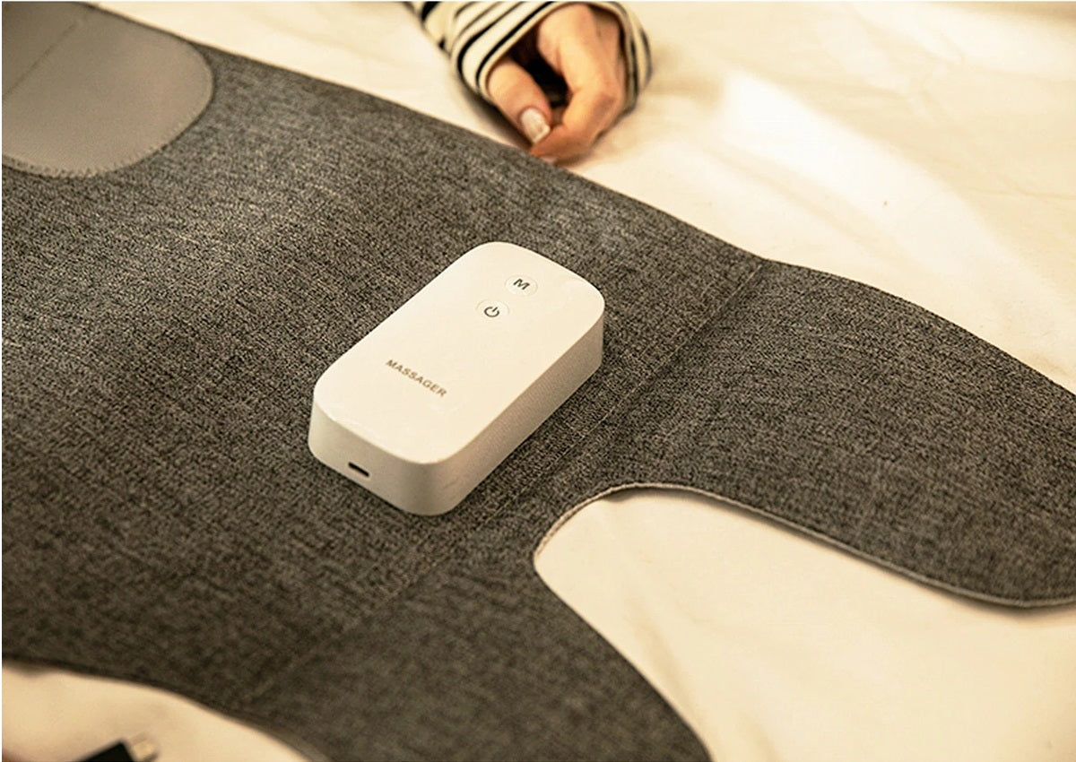 Gray heating pad with a white control device on a light background