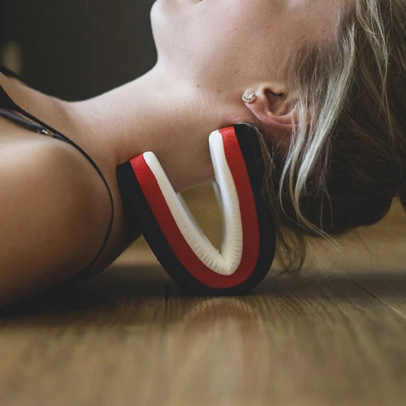 Person wearing red, white, and black headphones on a wooden floor
