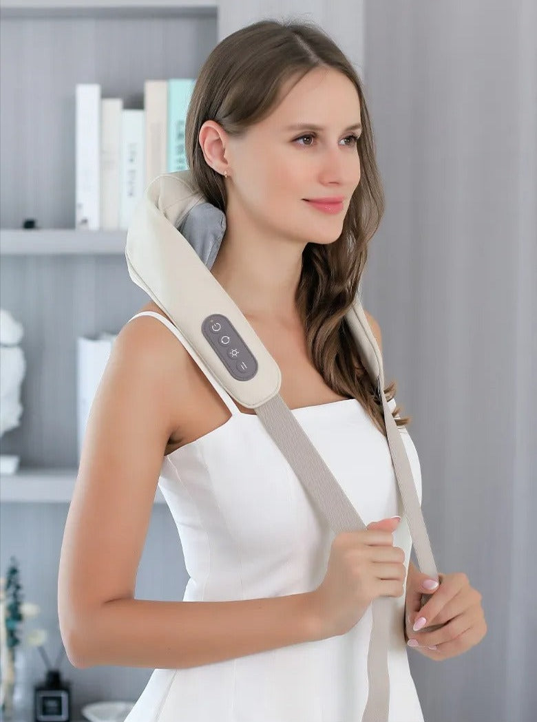 Woman using a neck and shoulder massager in a home setting